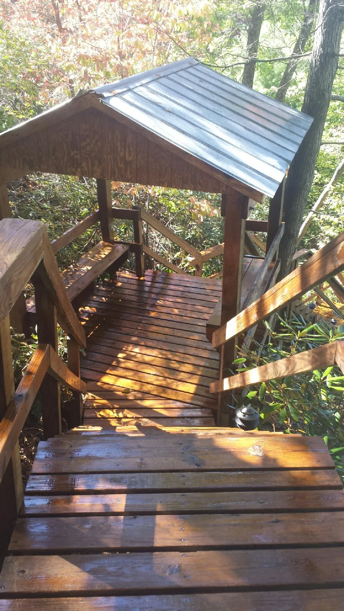 Freshly stained wood walkway and covered shelter with a metal roof in Milltown